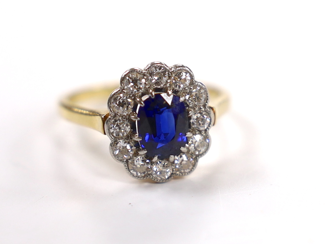 A 1940's/1950's 18ct, sapphire and millegrain set diamond oval cluster ring, size L/M, gross weight 3 grams.